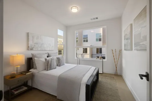 a bedroom with a bed and a lamp