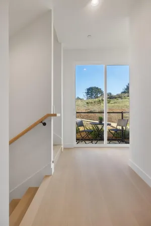 an empty room with sliding door and mountain view