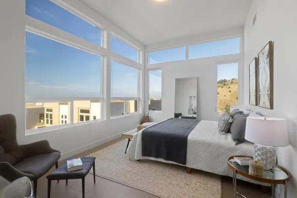 a bedroom with a bed and a couch