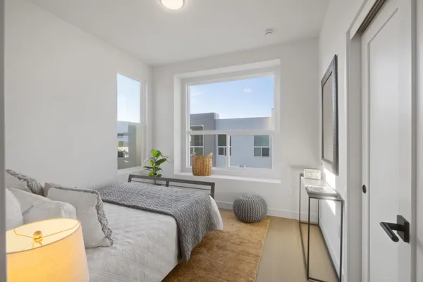 a bedroom with a bed and a couch