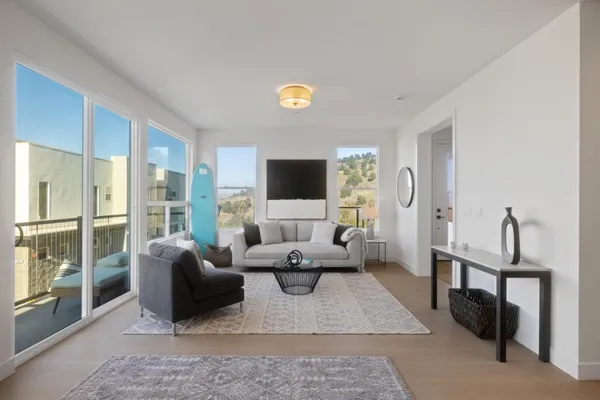 a living room with furniture a rug and a flat screen tv
