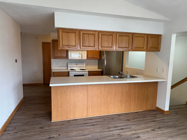 a kitchen with stainless steel appliances granite countertop a stove a refrigerator and a microwave