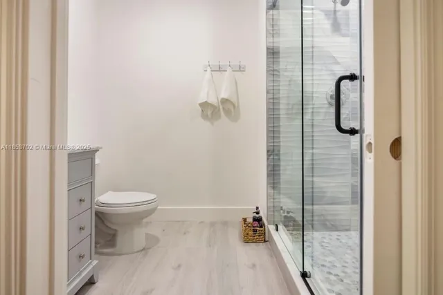 a bathroom with a toilet and shower
