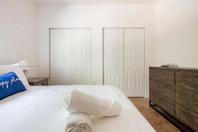 a bedroom with a bed and cabinet