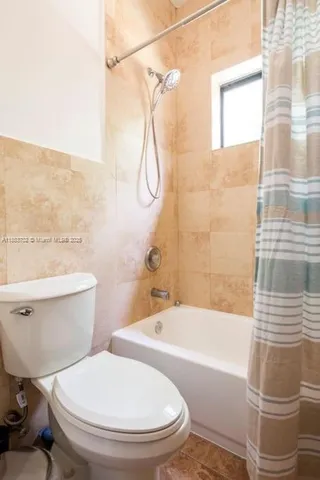 a bathroom with a toilet and a bathtub