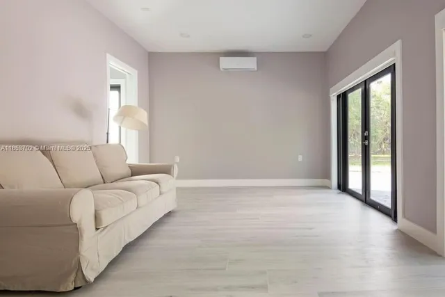 a room with a bed and a large window