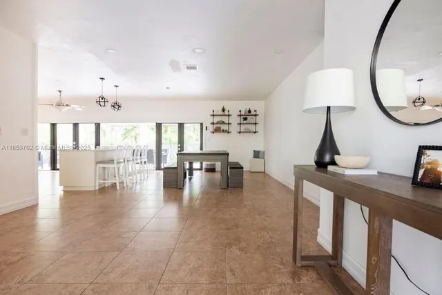 a living room with furniture and a mirror