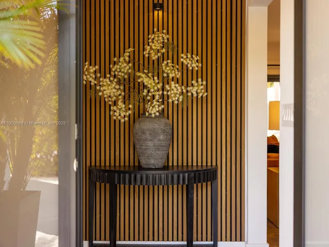 a dining room with stainless steel appliances kitchen island granite countertop a table chairs and a refrigerator