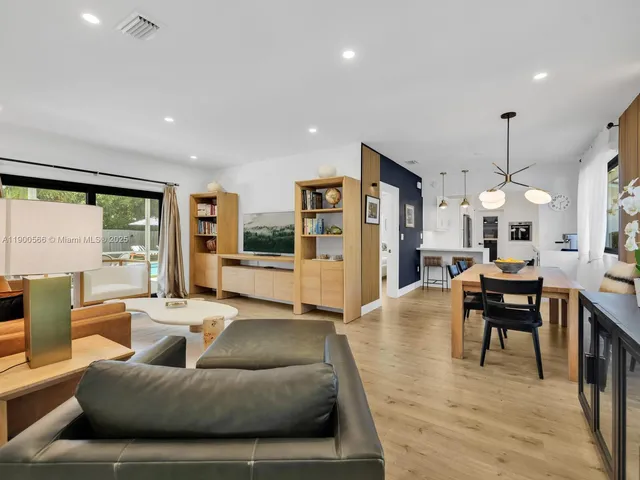 a view of living room with granite countertop cabinets and flat screen tv