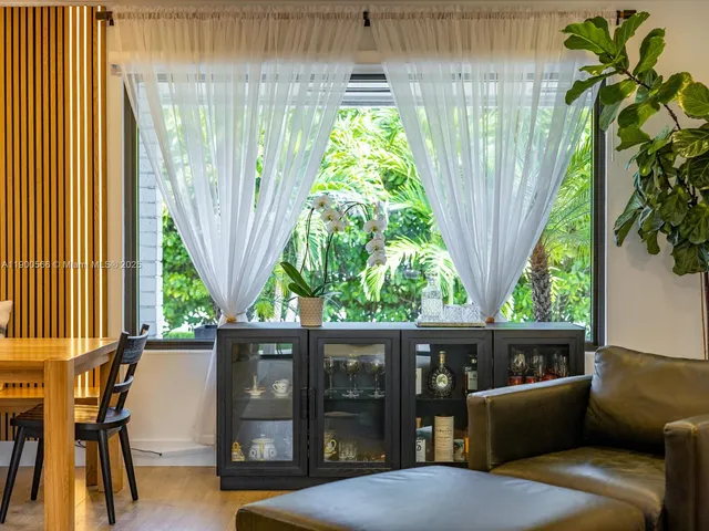 a bedroom with a bed and a potted plant