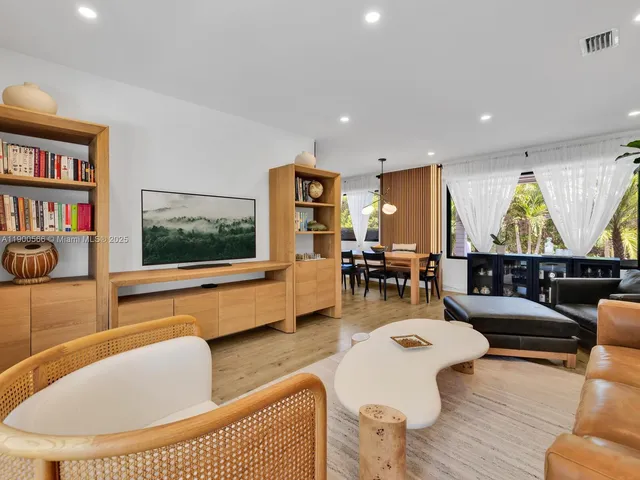 a view of a house with swimming pool and sitting area