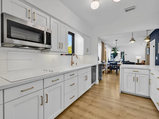 a view of a workspace with furniture and a potted plant