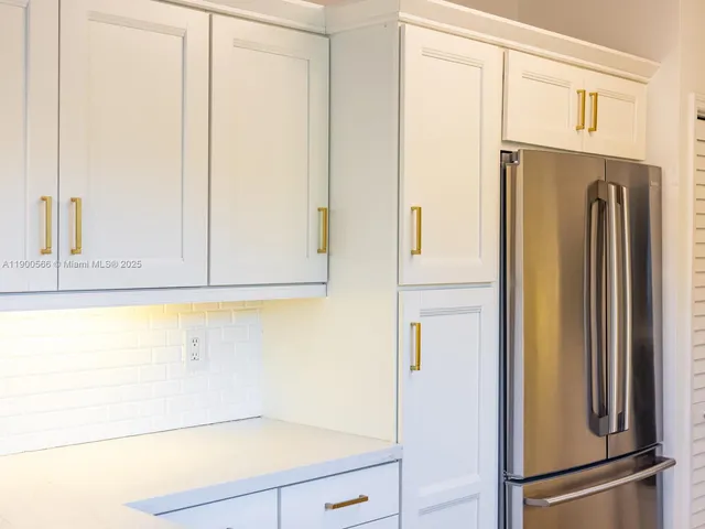 a view of a workspace with furniture and a potted plant