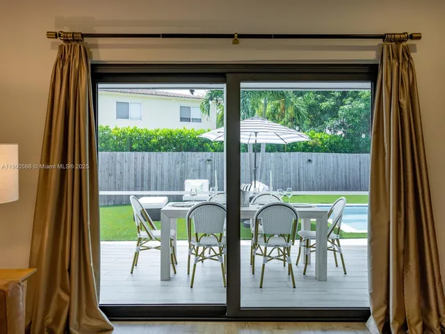 a view of a patio with a table chairs and a table
