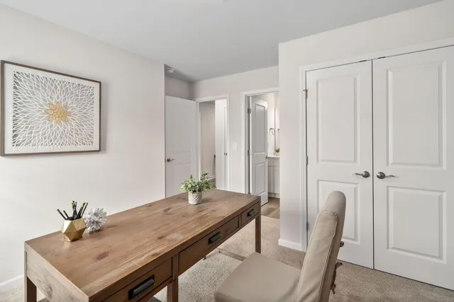 a room with a table chairs and wooden floor