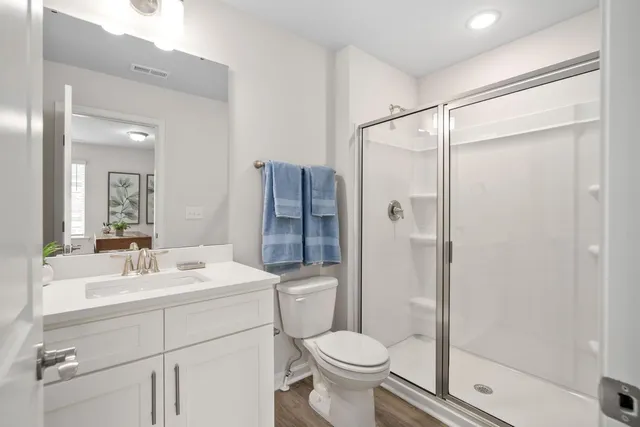 a bathroom with a sink toilet and shower