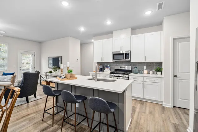 a kitchen with appliances a sink and cabinets