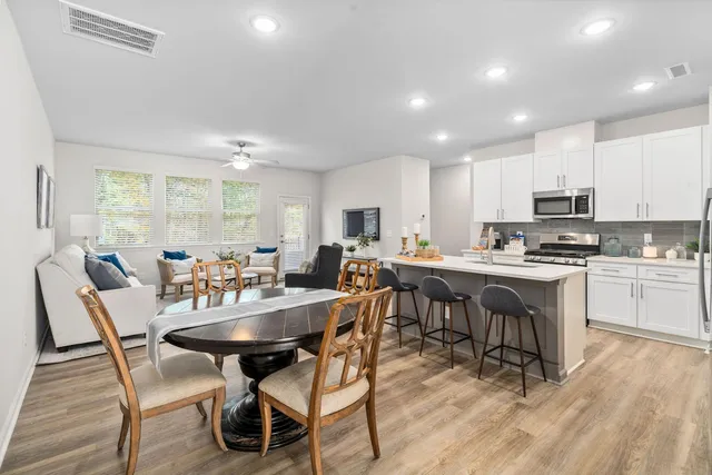 a view of kitchen with cabinets table and chairs