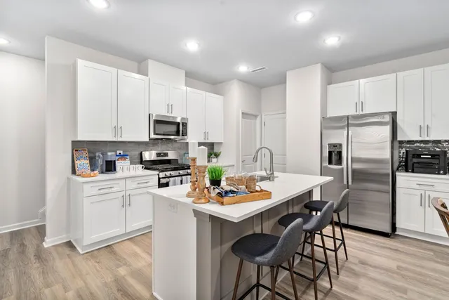 a kitchen with a dining table and chairs