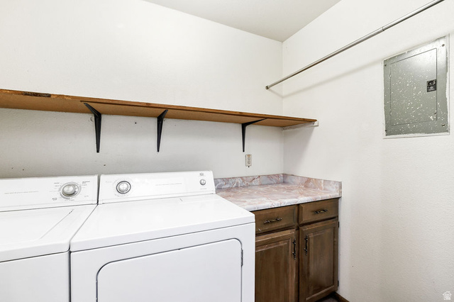 299 West Center Street, Unit 2 Logan, UT 84321 - Photo 24 of 46 Dedicated laundry area featuring a wood-finish shelf, hanging rod, wood-finish cabinetry, and a marbled countertop