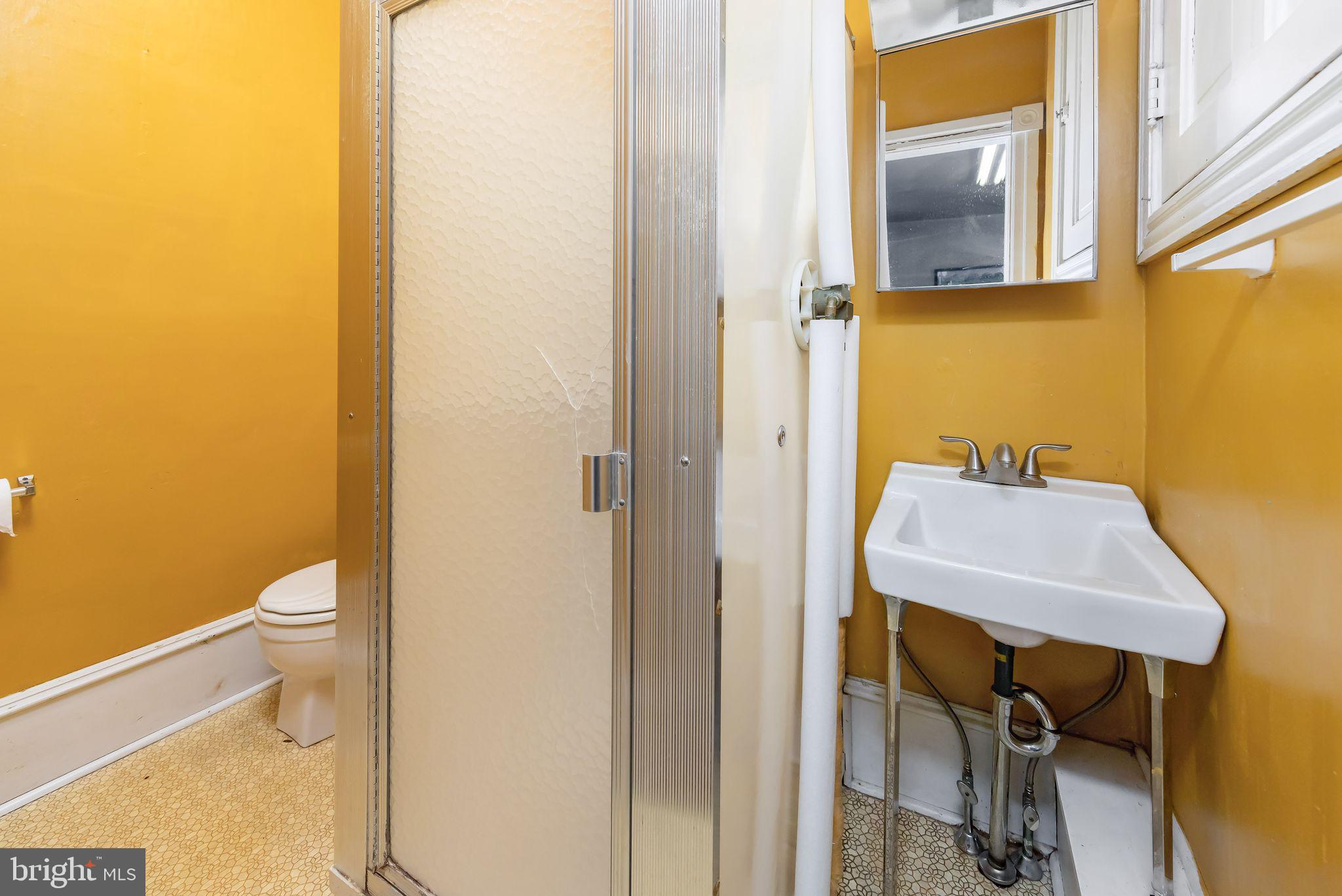 504 West Broad Street Gibbstown, NJ 08027 - Photo 13 of 37 a bathroom with a sink and a toilet