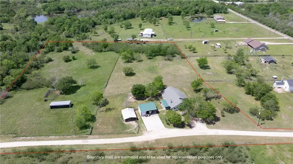 a living room with furniture and a ceiling fan