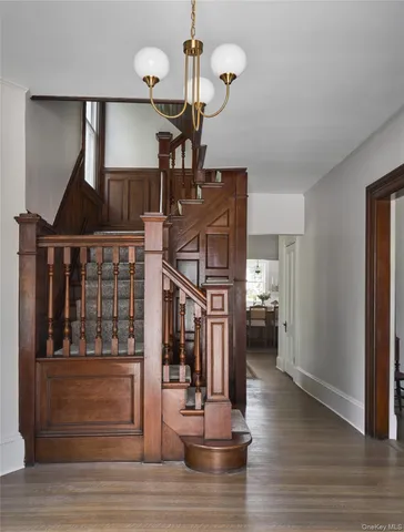a view of entryway and hall with wooden floor