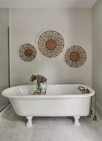 a bathroom with a bathtub and a window