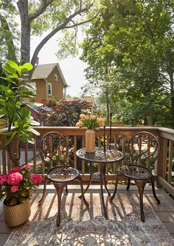 a view of balcony with wooden benches and seating