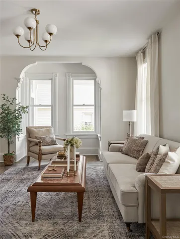 a living room with furniture and a potted plant