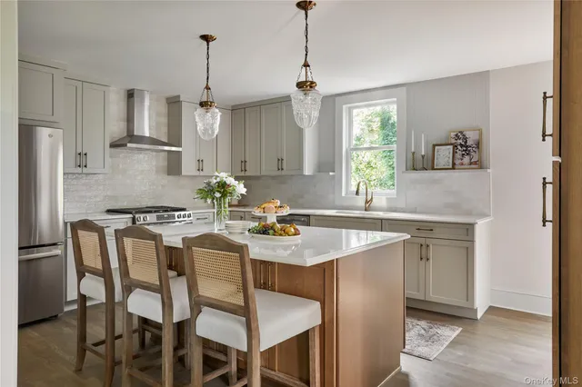 a kitchen with granite countertop white cabinets and stainless steel appliances