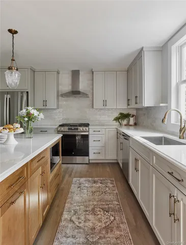 a kitchen with stainless steel appliances granite countertop a sink stove and cabinets