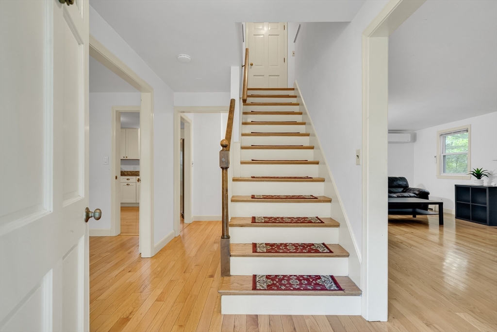 32 Dewey Road Lexington, MA 02420 - Photo 3 of 32 a view of a bedroom with wooden floor and stairs
