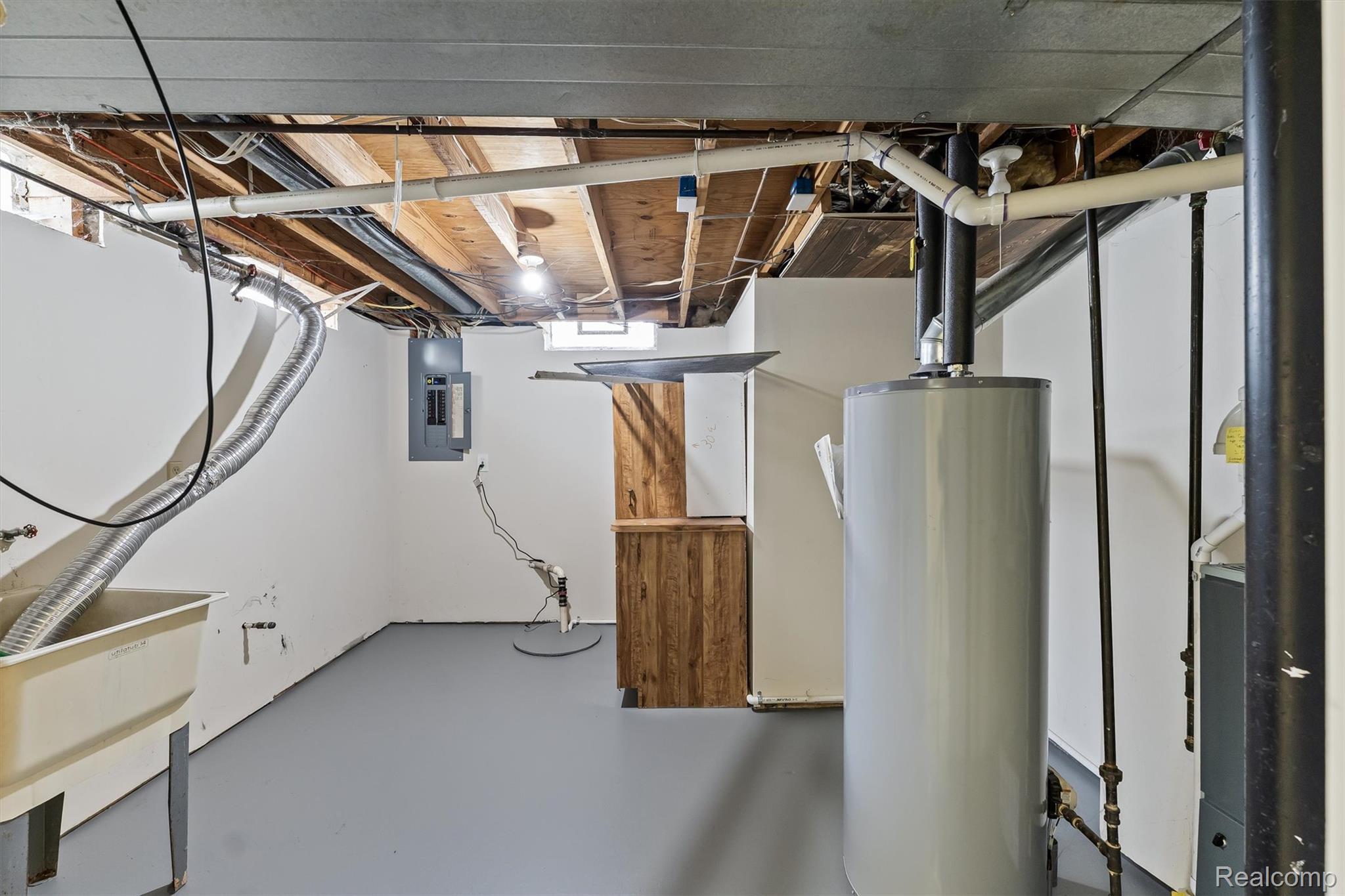 39861 Rager Court Clinton Township, MI 48038 - Photo 24 of 26 Utility room with exposed ceiling joists, grey painted floor, and a utility sink