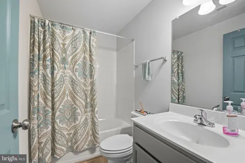 a bathroom with a sink a toilet and a bathtub