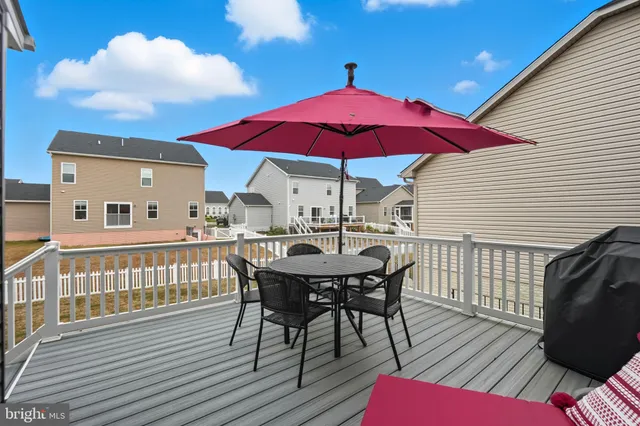 a view of house with a deck and furniture