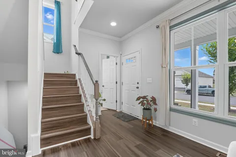 a view of entryway with wooden floor and stairs