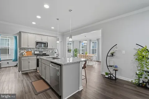 a kitchen with sink cabinets and wooden floor