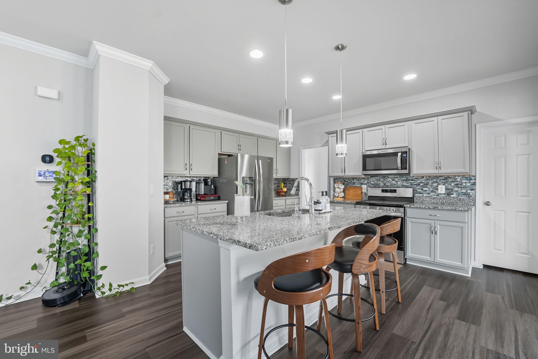119 Interlace Way Stephenson, VA 22656 - Photo 5 of 22 a kitchen with granite countertop a stove a sink a refrigerator and a fireplace