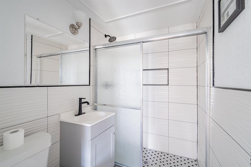 5305 Reiger Avenue, Unit 2 Dallas, TX 75214 - Photo 10 of 15 a bathroom with a sink toilet and shower