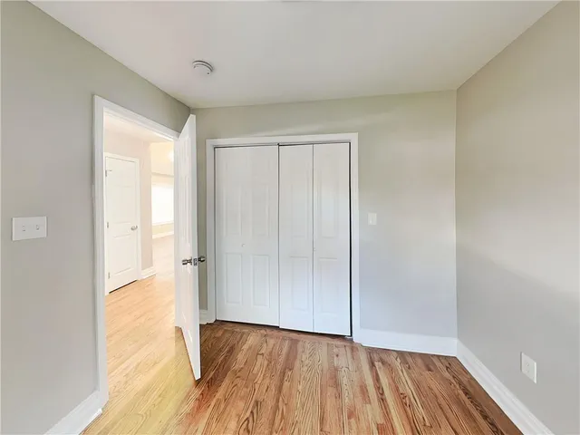 a view of an empty room and wooden floor