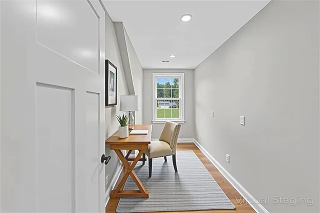 a dining room with furniture and wooden floor
