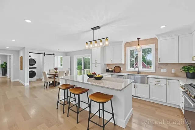 a kitchen with sink table and chairs