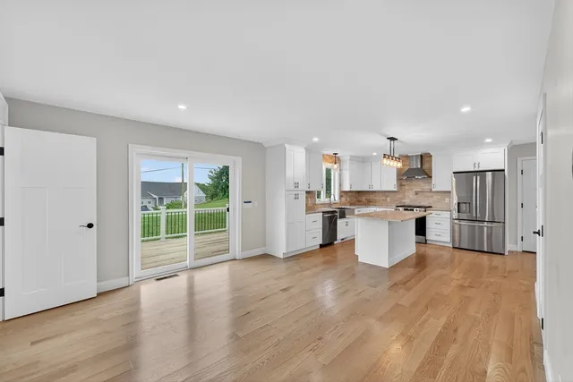 a open kitchen with white cabinets and stainless steel appliances