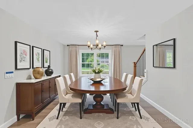a dining room with furniture a chandelier and wooden floor