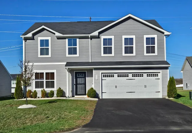 a view of a patio with a table and chairs and a barbeque
