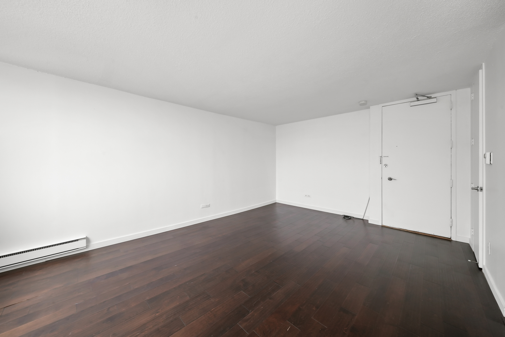 3110 North Sheridan Road, Unit 1207 Chicago, IL 60657 - Photo 12 of 32 an empty room with wooden floor