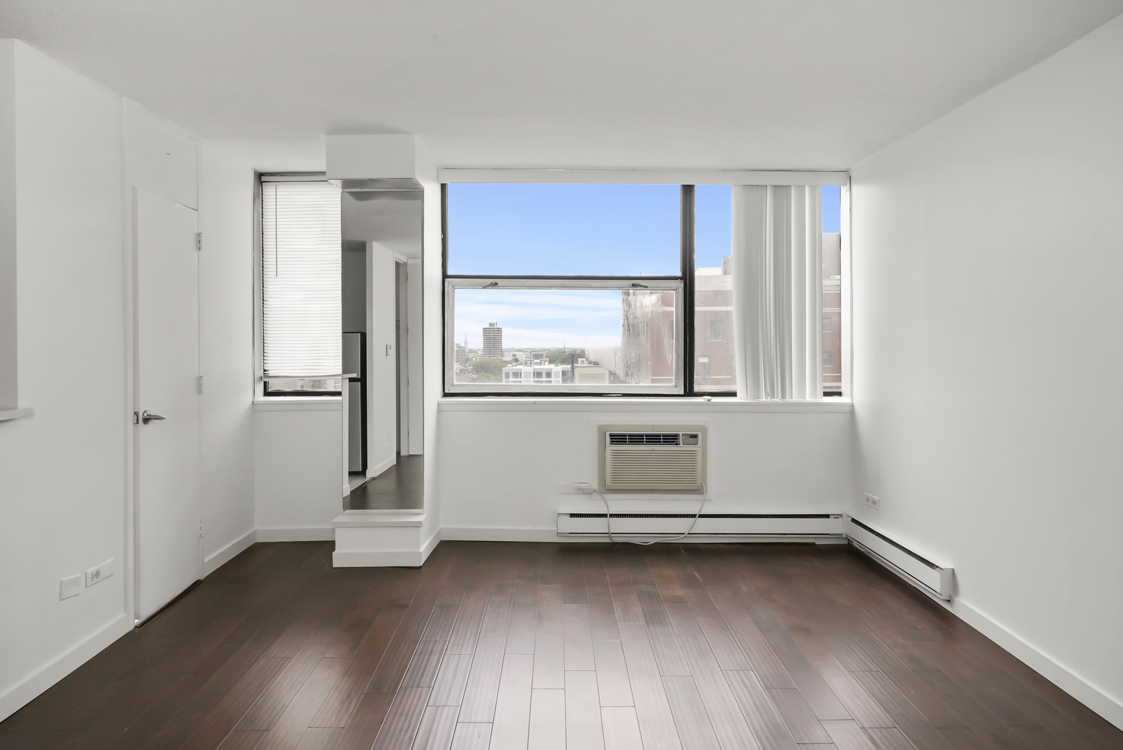 3110 North Sheridan Road, Unit 1207 Chicago, IL 60657 - Photo 14 of 32 wooden floor in an empty room with a window