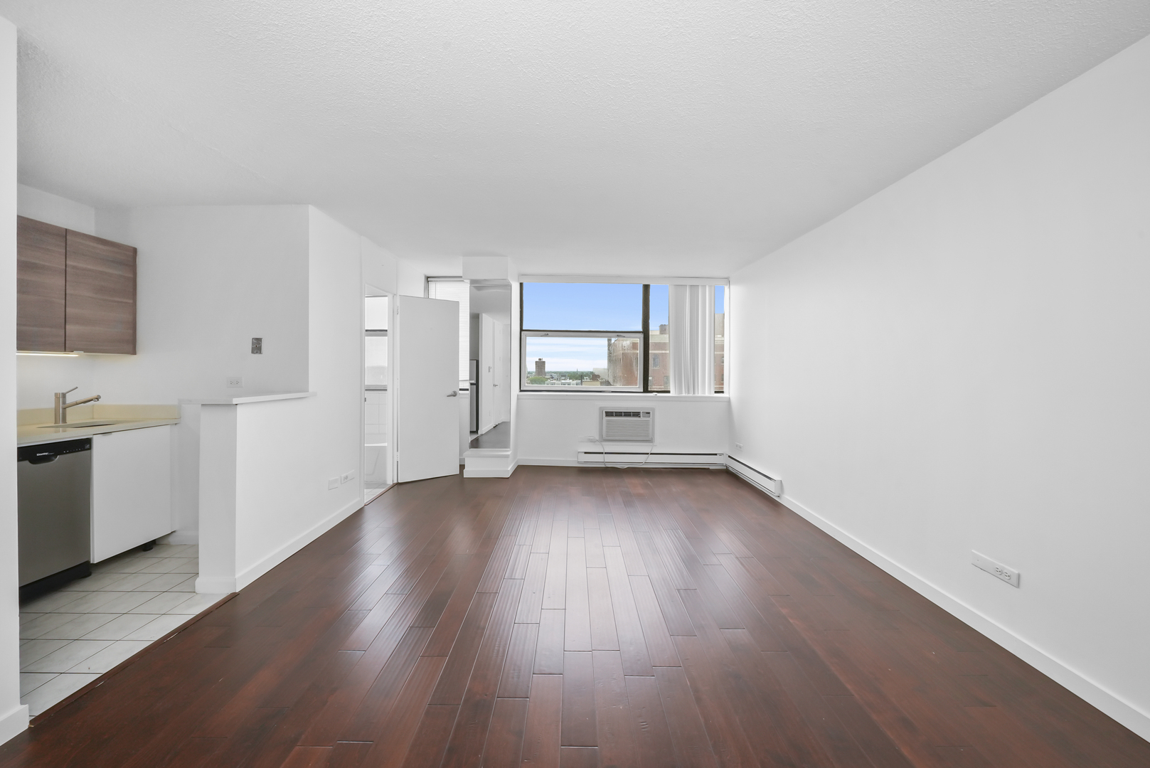 3110 North Sheridan Road, Unit 1207 Chicago, IL 60657 - Photo 15 of 32 a view of a kitchen with wooden floor and electronic appliances