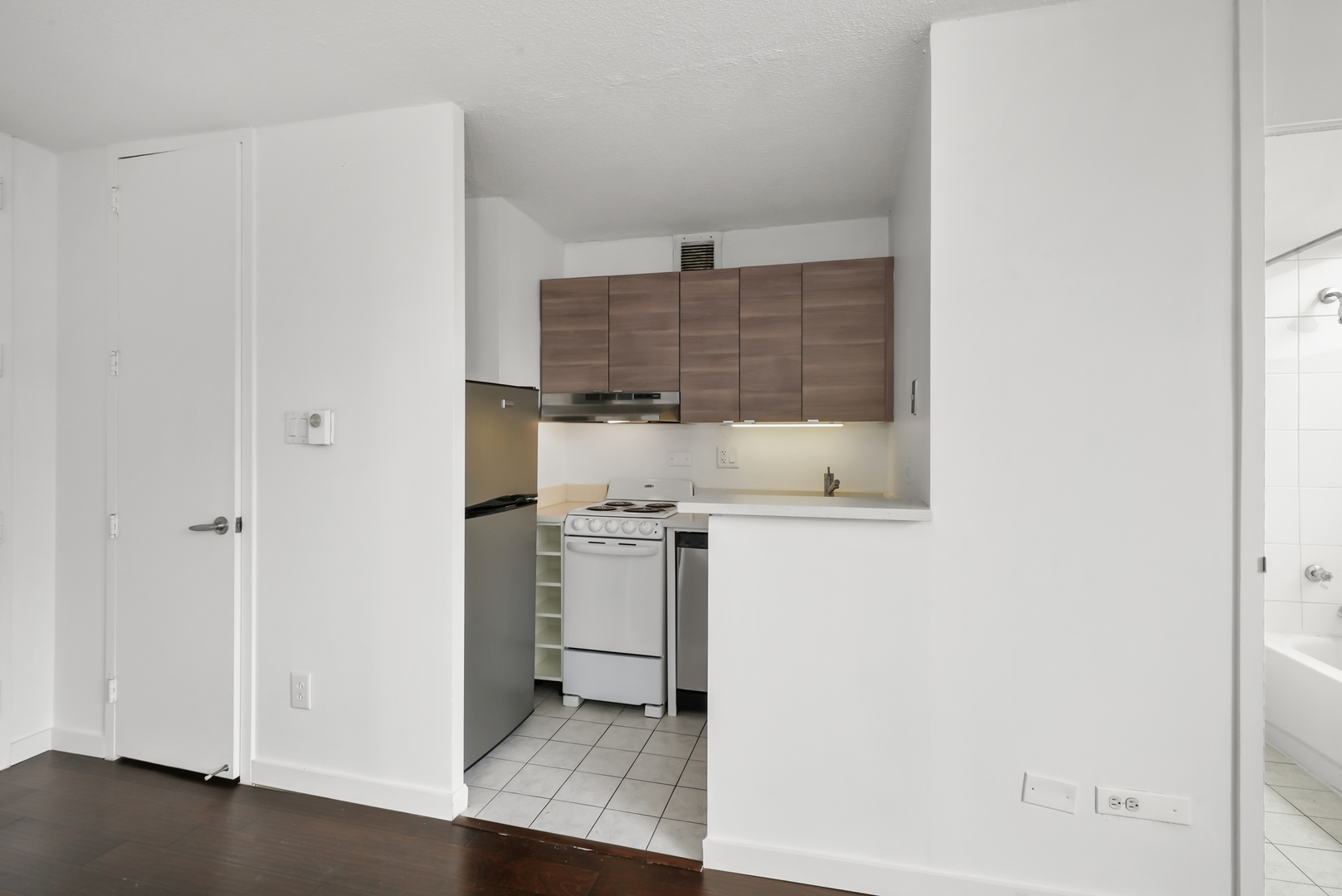 3110 North Sheridan Road, Unit 1207 Chicago, IL 60657 - Photo 17 of 32 a kitchen with stainless steel appliances a refrigerator and a stove